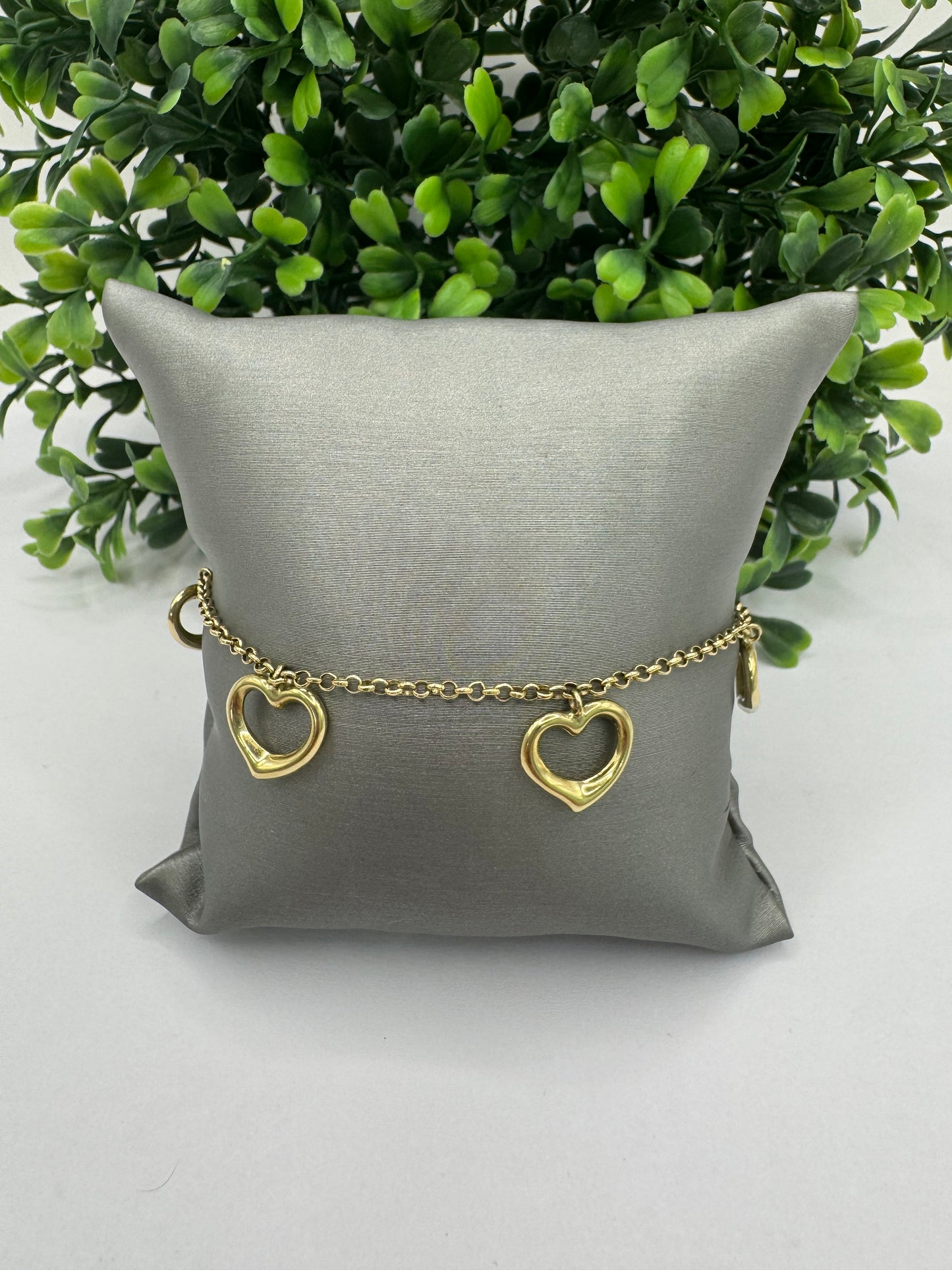 Pulsera rolo con corazones colgantes.